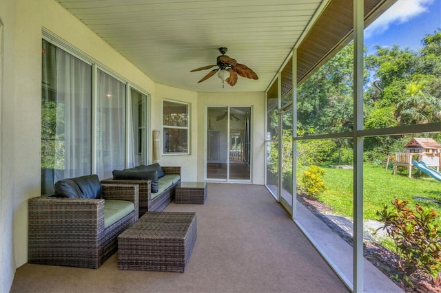 sunroom featuring ceiling fan