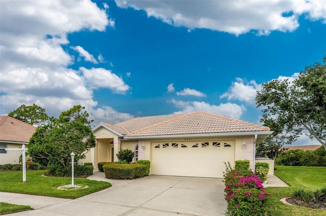 view of front of property featuring a garage and a front yard