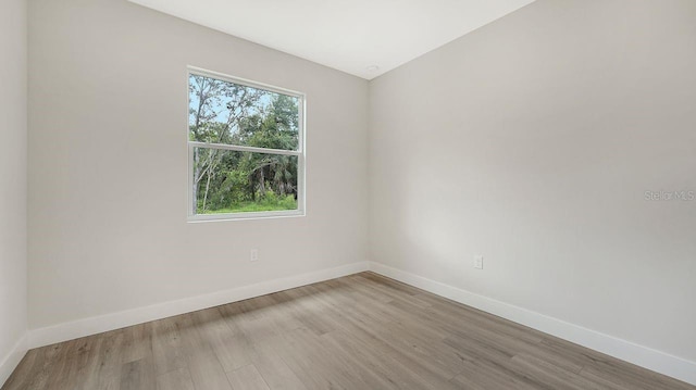 empty room with light hardwood / wood-style flooring