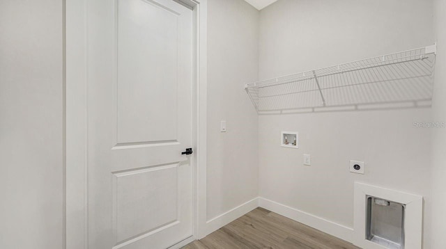 clothes washing area featuring hookup for a washing machine, hardwood / wood-style floors, and electric dryer hookup