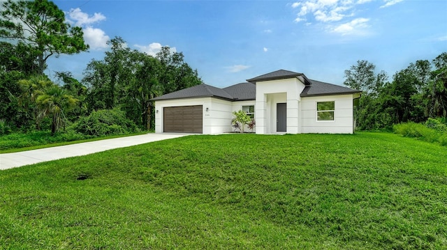 view of front facade with a garage and a front lawn