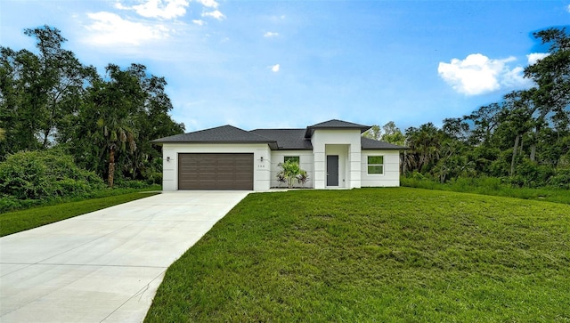 view of front facade with a garage and a front lawn