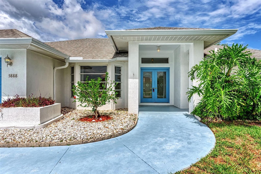 view of exterior entry featuring french doors