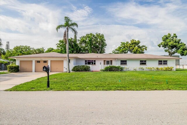 single story home featuring a garage and a front yard