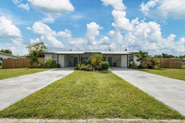 ranch-style house with a carport and a front yard