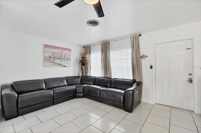 living room featuring ceiling fan and light tile patterned flooring