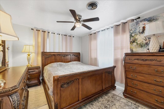 tiled bedroom featuring ceiling fan