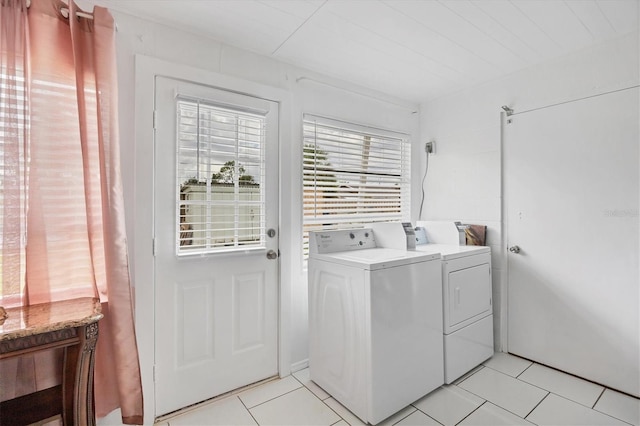 washroom with separate washer and dryer and light tile patterned floors