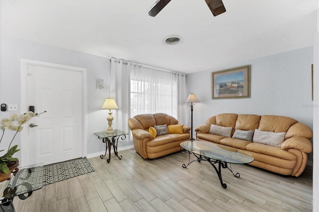 living room featuring ceiling fan and light hardwood / wood-style flooring