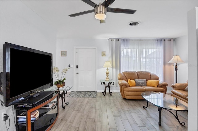 living room featuring ceiling fan and light hardwood / wood-style flooring