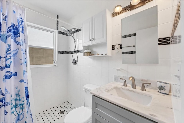 bathroom featuring vanity, toilet, a shower with curtain, and tile walls