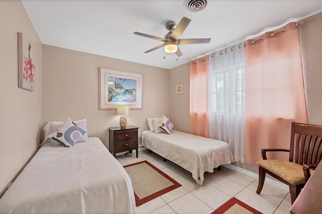 tiled bedroom with ceiling fan