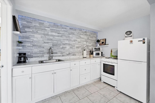 kitchen featuring white appliances, light tile patterned floors, backsplash, sink, and white cabinets