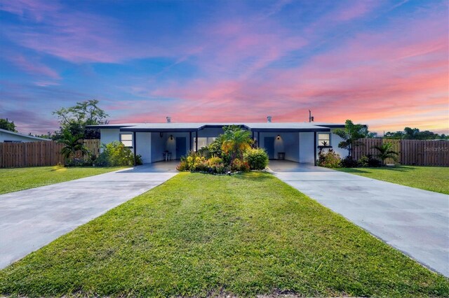 ranch-style home with a yard and a carport