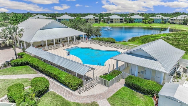 view of swimming pool with a water view, a lawn, and a patio area