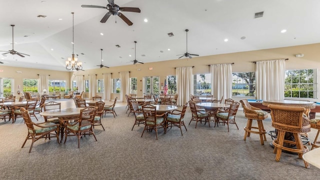 dining area with high vaulted ceiling, a notable chandelier, and carpet floors