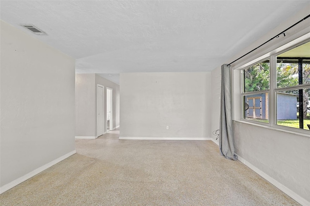 spare room featuring a textured ceiling