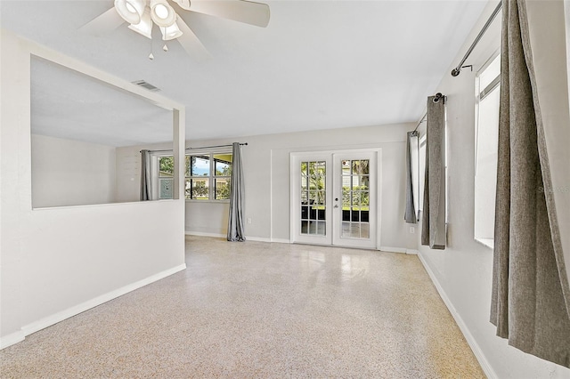 unfurnished living room with french doors and ceiling fan