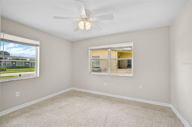 carpeted spare room with ceiling fan