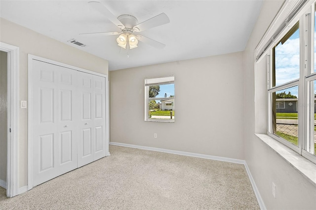 unfurnished bedroom featuring a closet, carpet flooring, and ceiling fan