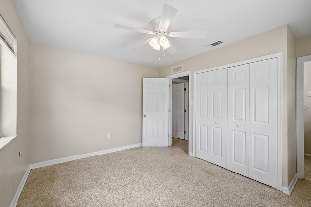 unfurnished bedroom with light colored carpet, a closet, and ceiling fan