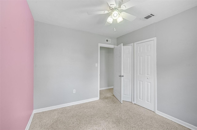 unfurnished bedroom with light colored carpet and ceiling fan