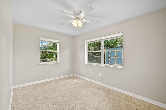 spare room with carpet floors and ceiling fan