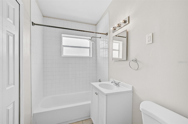 full bathroom featuring tile patterned flooring, tiled shower / bath combo, toilet, and vanity