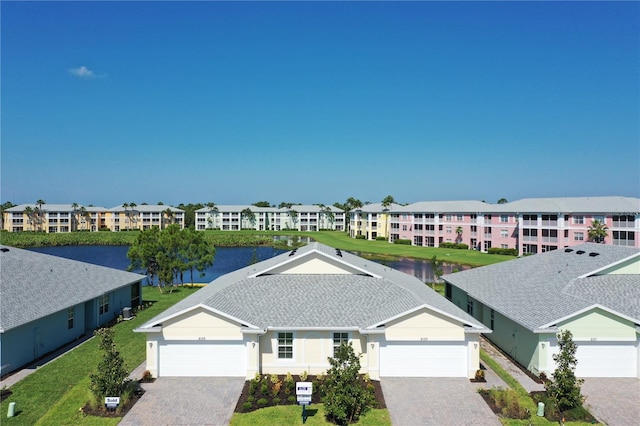 drone / aerial view with a water view and a residential view