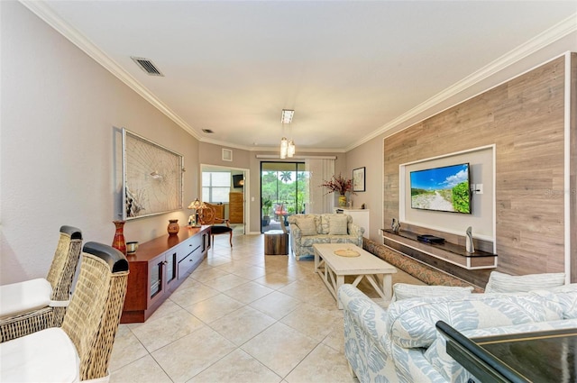 living room featuring ornamental molding and light tile patterned flooring