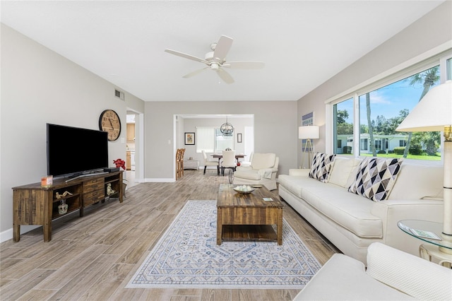 living room with ceiling fan and plenty of natural light