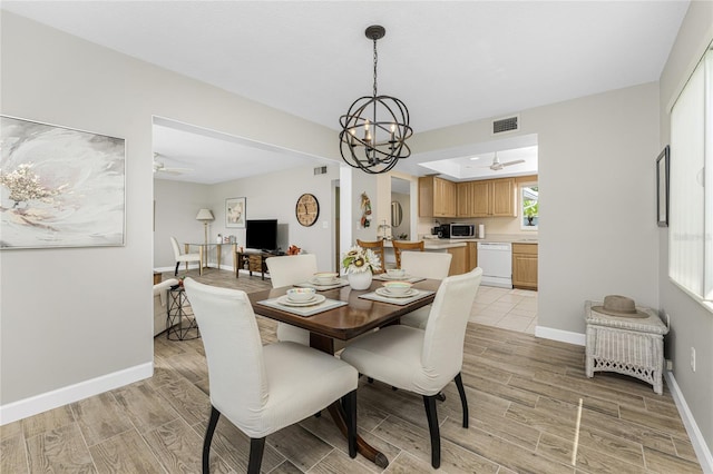 dining room featuring ceiling fan with notable chandelier