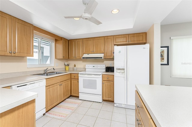 kitchen featuring ceiling fan, sink, a tray ceiling, white appliances, and light tile patterned floors