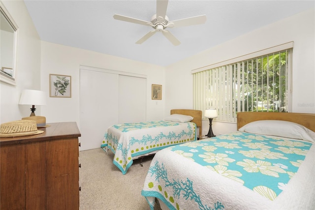 bedroom featuring ceiling fan, a closet, and carpet flooring