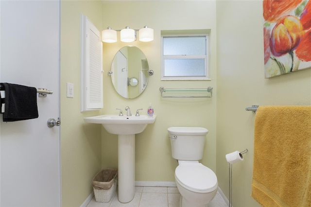 bathroom featuring toilet and tile patterned flooring