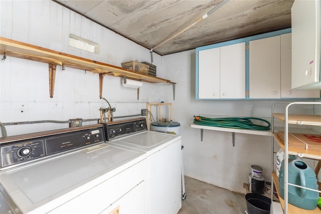 laundry area featuring washer and dryer, cabinets, and water heater