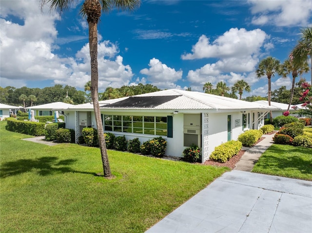 ranch-style home featuring a front yard