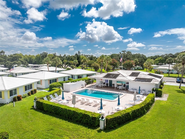 view of swimming pool featuring a yard and a patio