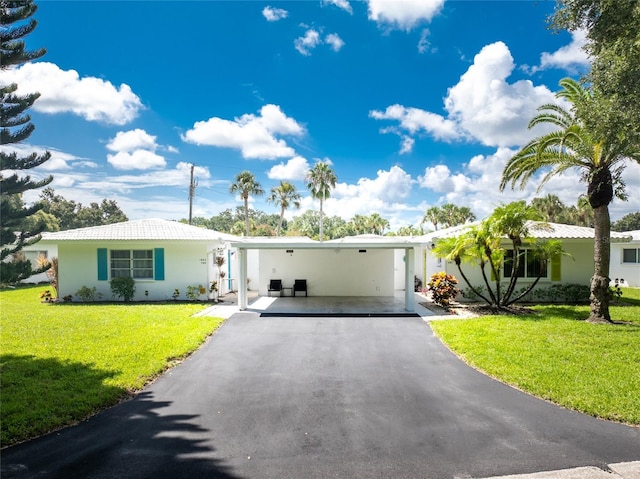 view of front facade with a front yard and a carport