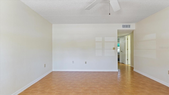 unfurnished room with a ceiling fan, baseboards, visible vents, a textured ceiling, and light wood-type flooring