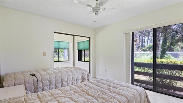 bedroom with a textured ceiling, a ceiling fan, and carpet floors