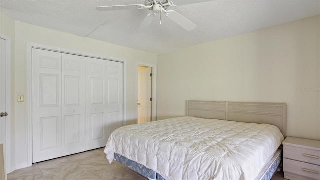 bedroom featuring a ceiling fan, a closet, and a textured ceiling