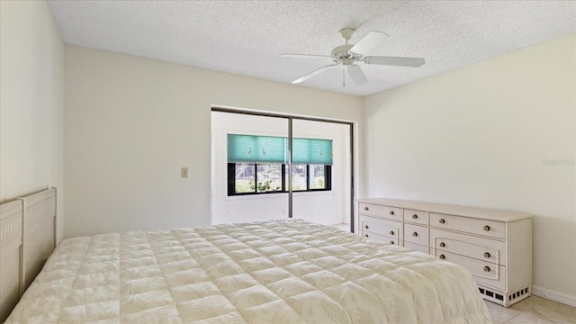 bedroom featuring a ceiling fan and a textured ceiling