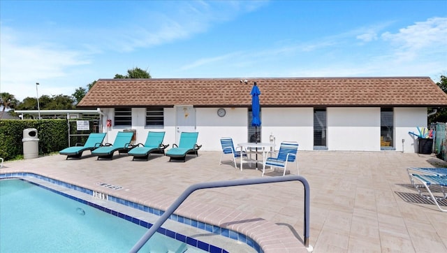 community pool featuring a patio area and fence