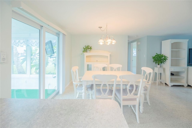 dining room featuring a chandelier and light speckled floor