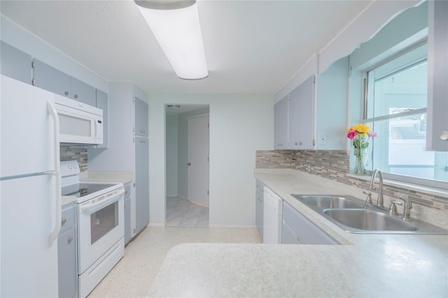 kitchen with sink, backsplash, and white appliances