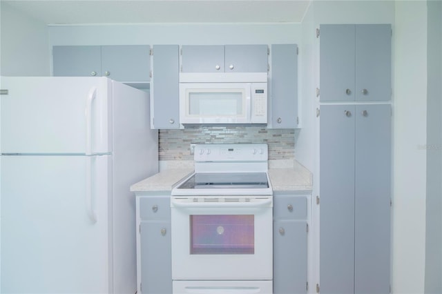 kitchen featuring tasteful backsplash and white appliances