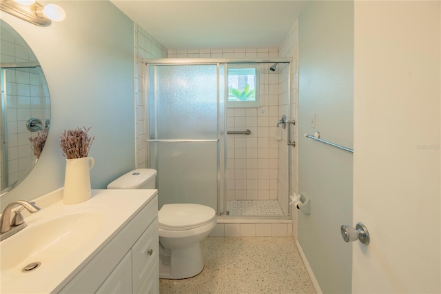 bathroom featuring speckled floor, a stall shower, vanity, and toilet