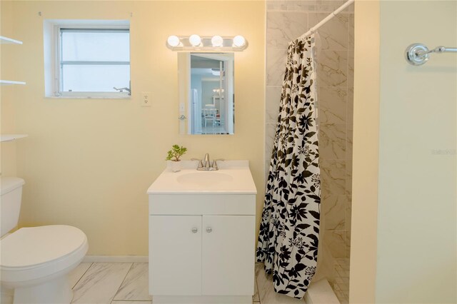 bathroom featuring tile patterned floors, vanity, and toilet