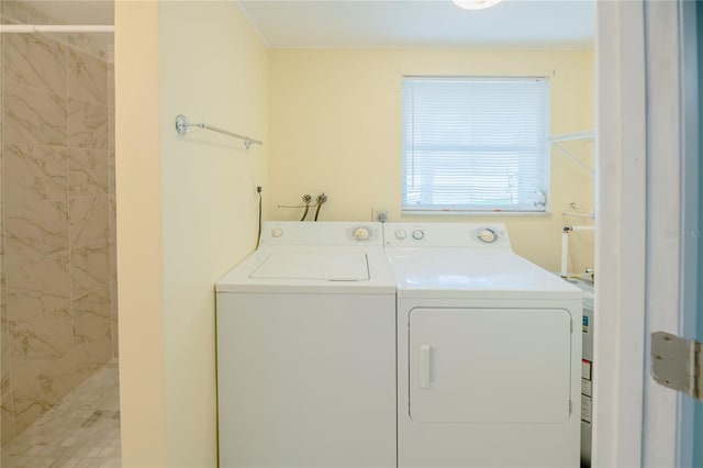 clothes washing area with laundry area and washer and clothes dryer